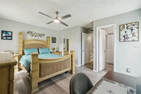 a bedroom with a bed and a chandelier