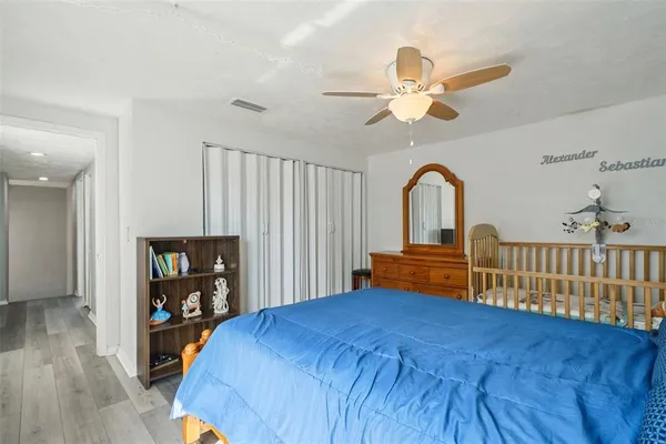 a bedroom with a bed and a bookshelf