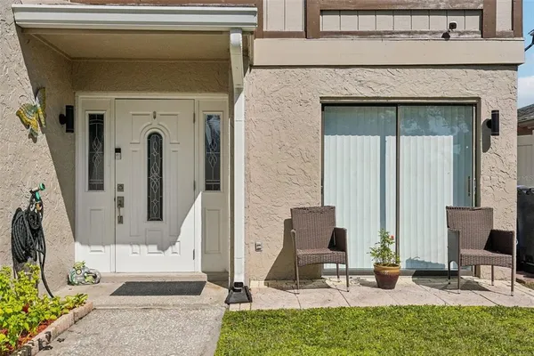 a front view of a house with outdoor seating