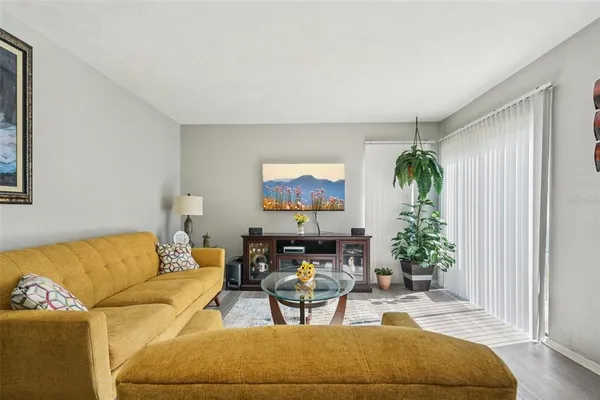 a living room with furniture and a potted plant
