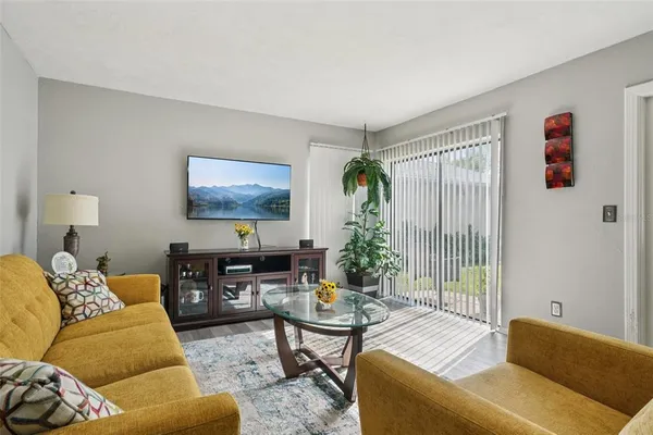 a living room with furniture and a potted plant