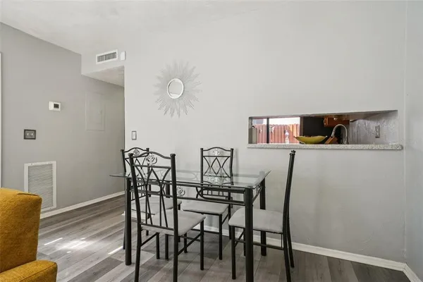 a view of a dining room with furniture and wooden floor