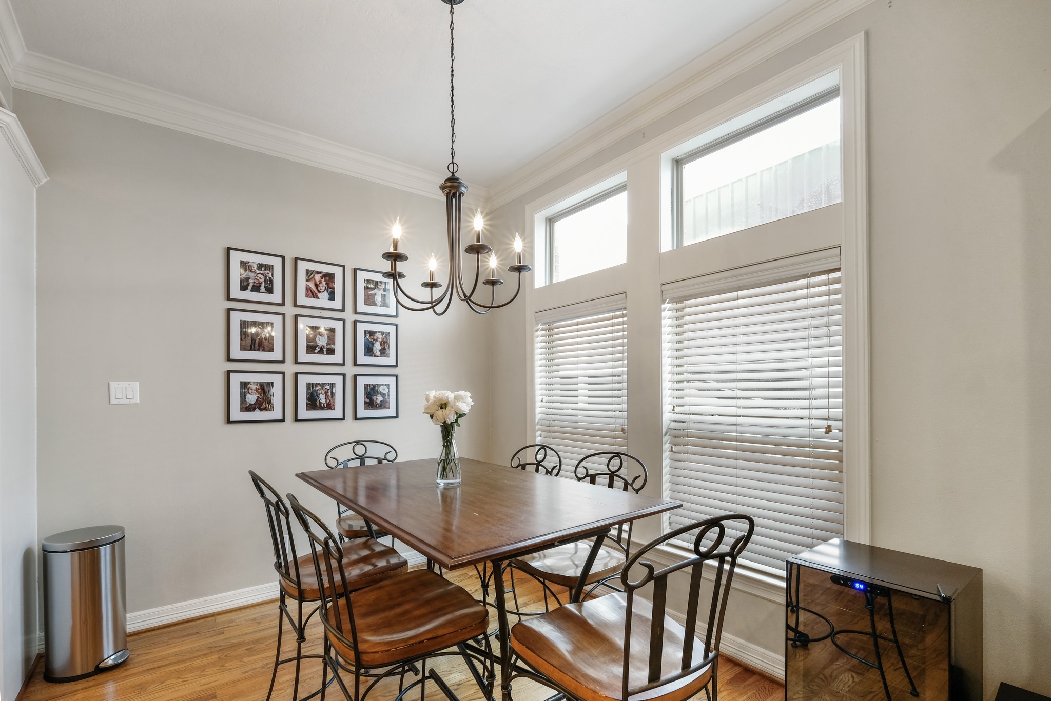 933 West 17th Street Houston, TX 77008 - Photo 4 of 19 Dining area with wood floors, a pendant lighting, large windows with privacy blinds and crown modling details.