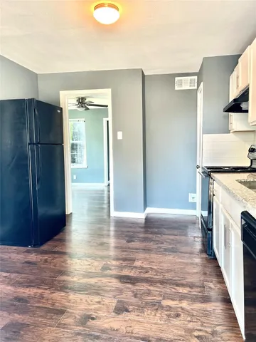 a view of a kitchen with a sink and a stove top oven