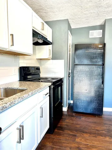 a bathroom with a sink mirror vanity and toilet