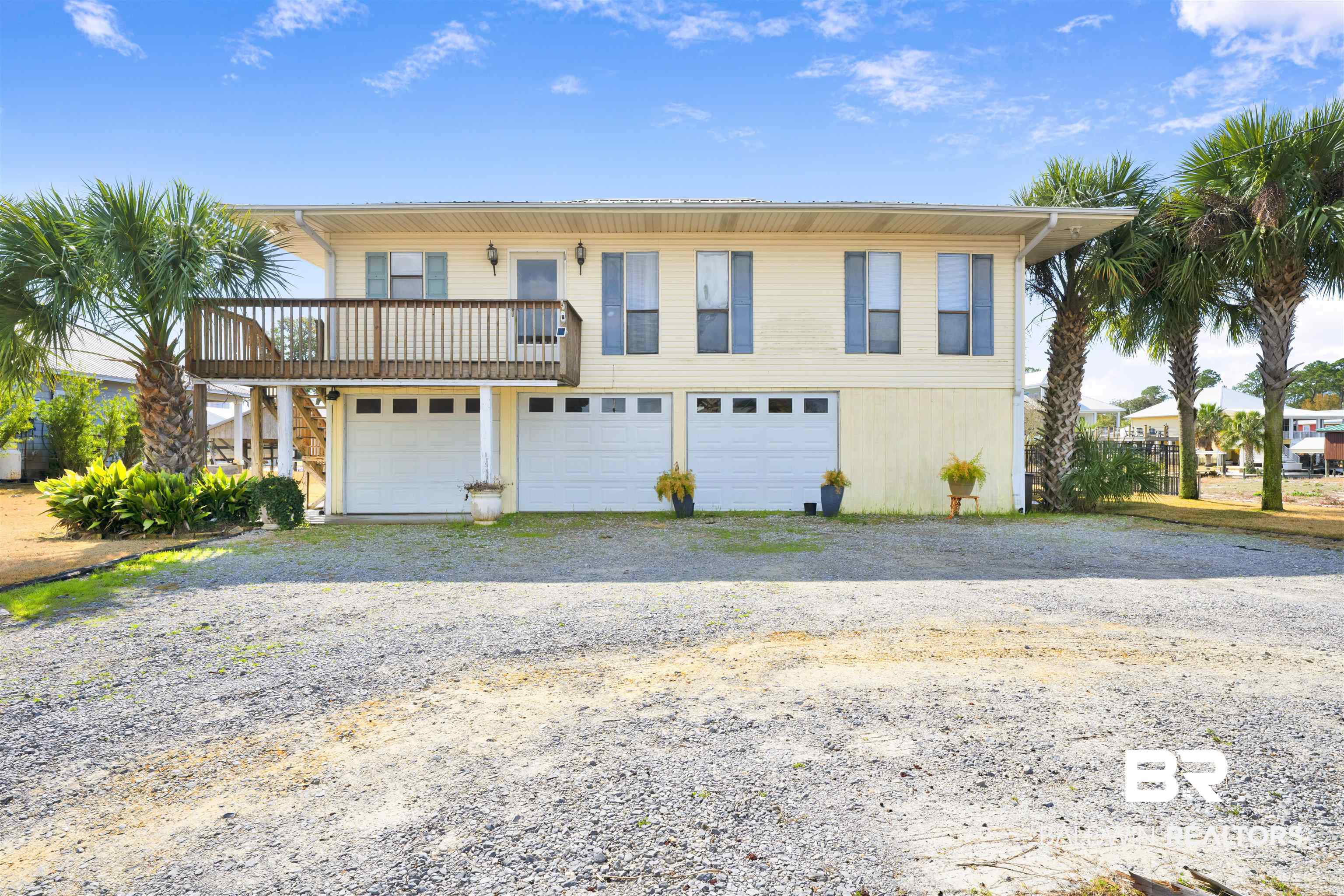 26222 Marina Road Orange Beach, AL 36561 - Photo 1 of 38 View of front of home with a garage, driveway, and a balcony