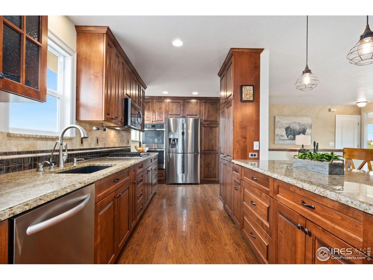 5100 Glen Drive Berthoud, CO 80513 - Photo 12 of 40 a large kitchen with granite countertop a sink and cabinets