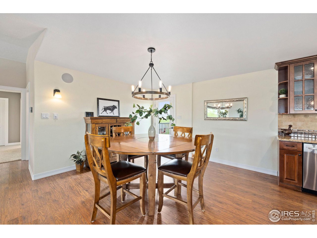 5100 Glen Drive Berthoud, CO 80513 - Photo 14 of 40 a dining room with furniture a chandelier and wooden floor