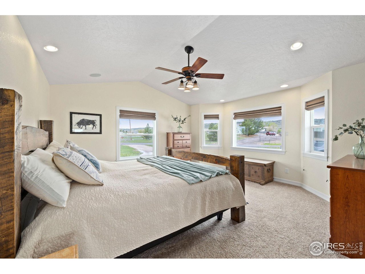 5100 Glen Drive Berthoud, CO 80513 - Photo 18 of 40 a bedroom with a large bed and a chandelier