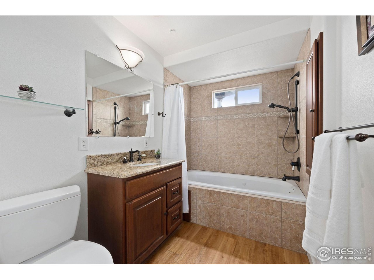 5100 Glen Drive Berthoud, CO 80513 - Photo 23 of 40 a bathroom with a granite countertop sink toilet and shower