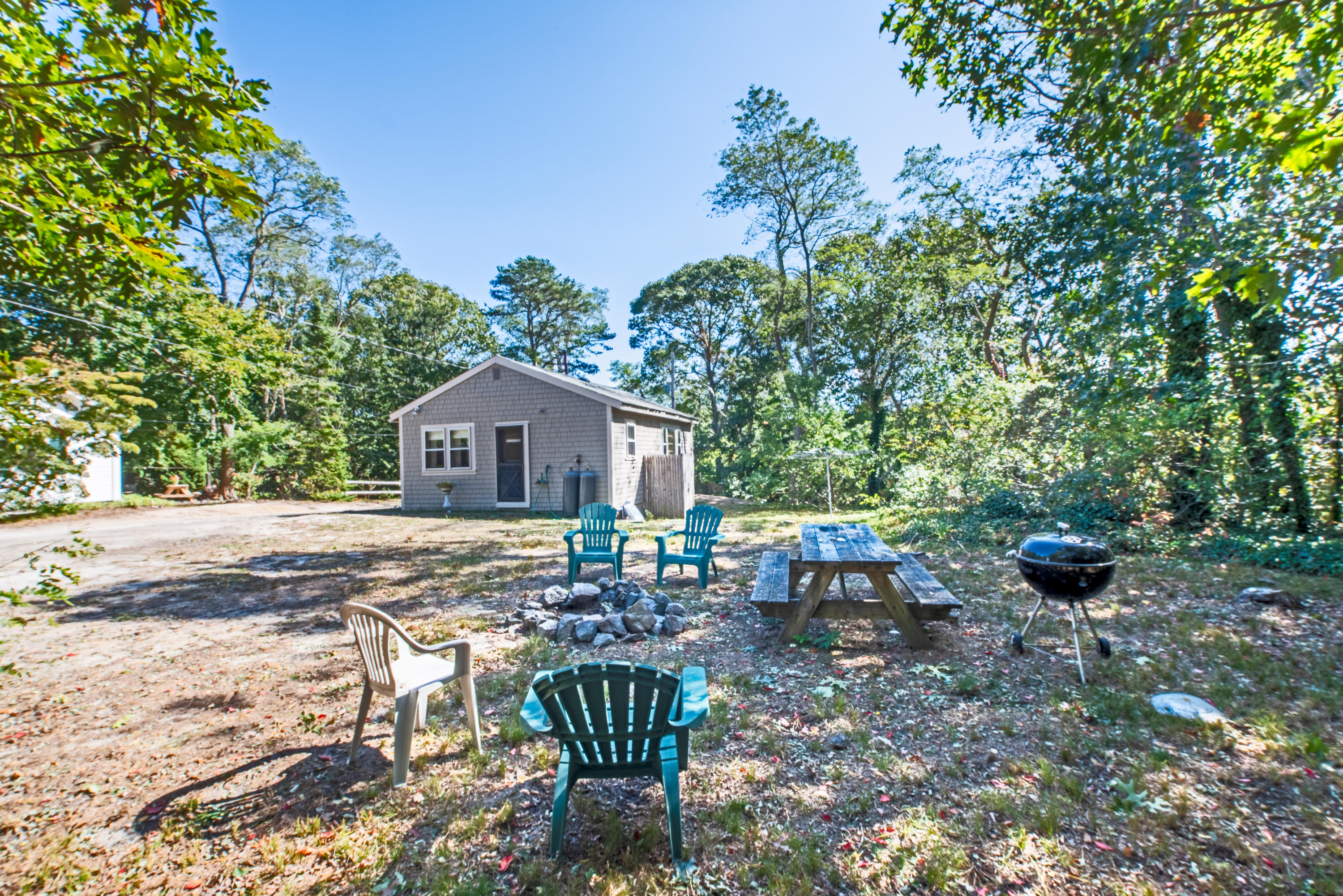 a backyard of a house with table and chairs