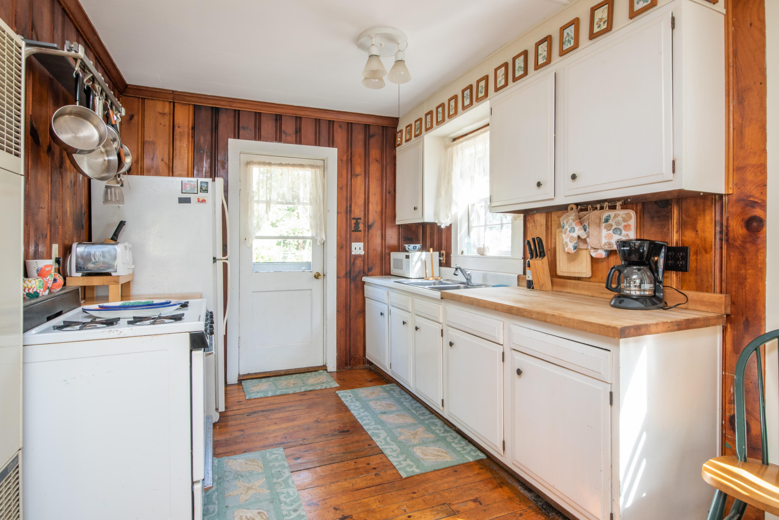 20 Baker Road, Unit B Wellfleet, MA 02667 - Photo 7 of 16 a kitchen with stainless steel appliances granite countertop a refrigerator a sink dishwasher a stove and white countertops with wooden floor