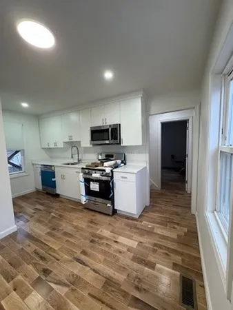 a kitchen with a refrigerator and a stove top oven