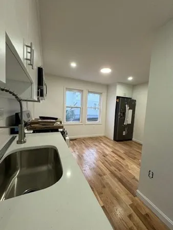 a kitchen with a sink and a stove top oven