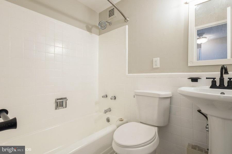 1301 Delaware Avenue Southwest, Unit N720 Washington, DC 20024 - Photo 18 of 20 a bathroom with a sink a toilet and shower