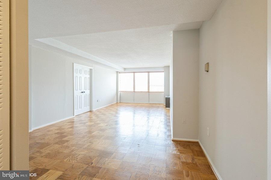 1301 Delaware Avenue Southwest, Unit N720 Washington, DC 20024 - Photo 6 of 20 a view of empty room with wooden floor and fan