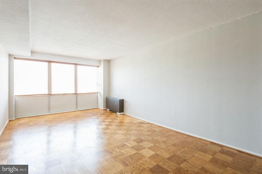 1301 Delaware Avenue Southwest, Unit N720 Washington, DC 20024 - Photo 7 of 20 a view of empty room with wooden floor and fan