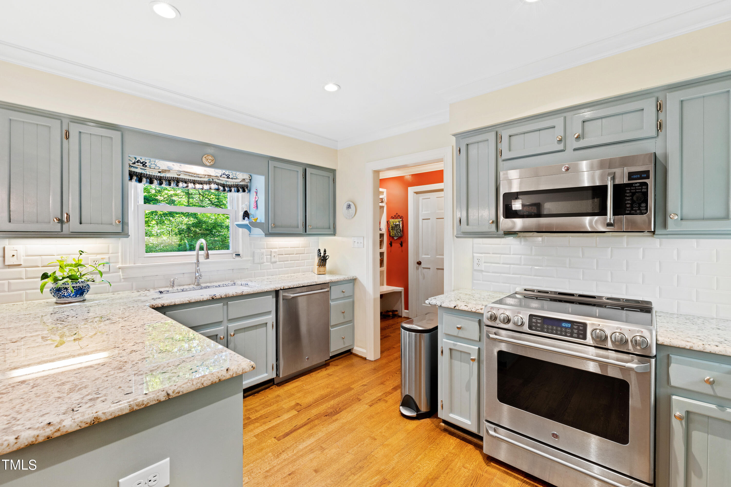 10212 Bushveld Lane Raleigh, NC 27613 - Photo 16 of 51 a kitchen with stainless steel appliances granite countertop a sink stove and microwave