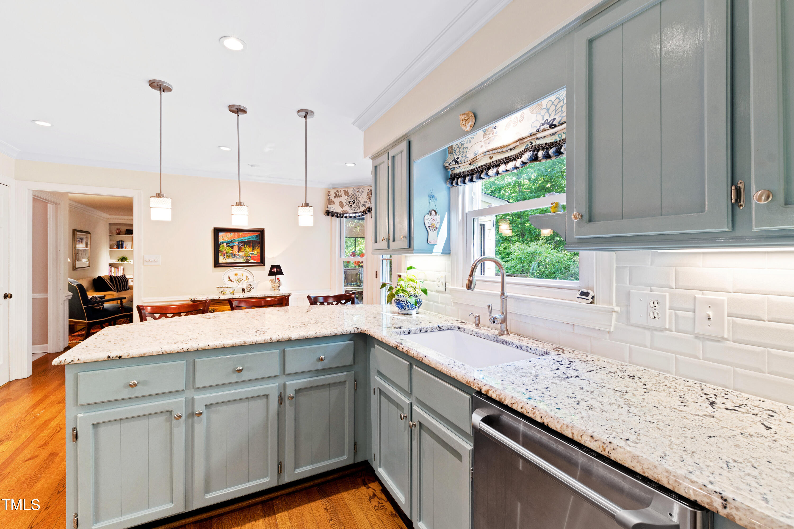 10212 Bushveld Lane Raleigh, NC 27613 - Photo 19 of 51 a kitchen with a sink window and cabinets