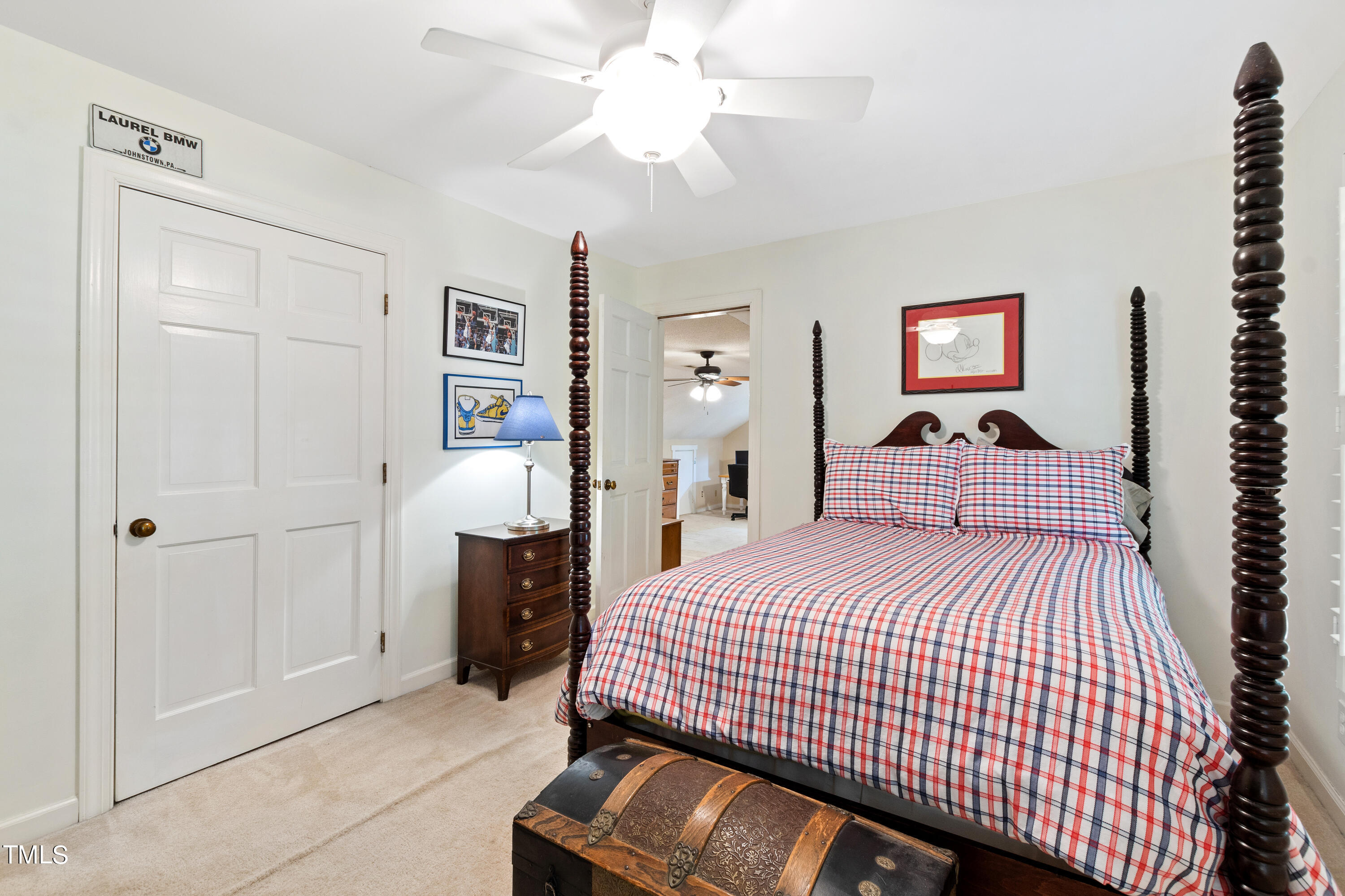 10212 Bushveld Lane Raleigh, NC 27613 - Photo 33 of 51 a bedroom with a bed and a chandelier