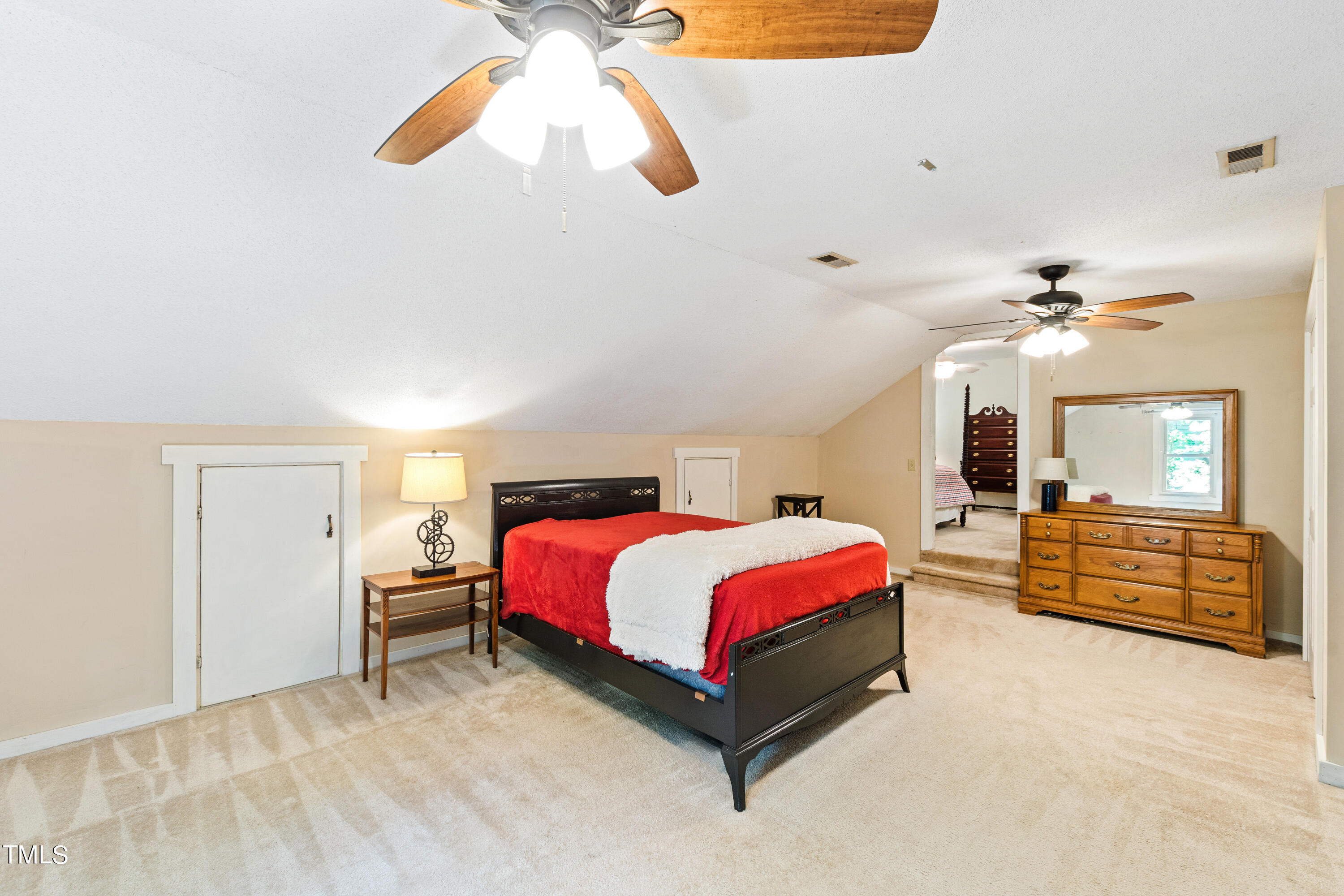 10212 Bushveld Lane Raleigh, NC 27613 - Photo 37 of 51 a spacious bedroom with a bed and a chandelier