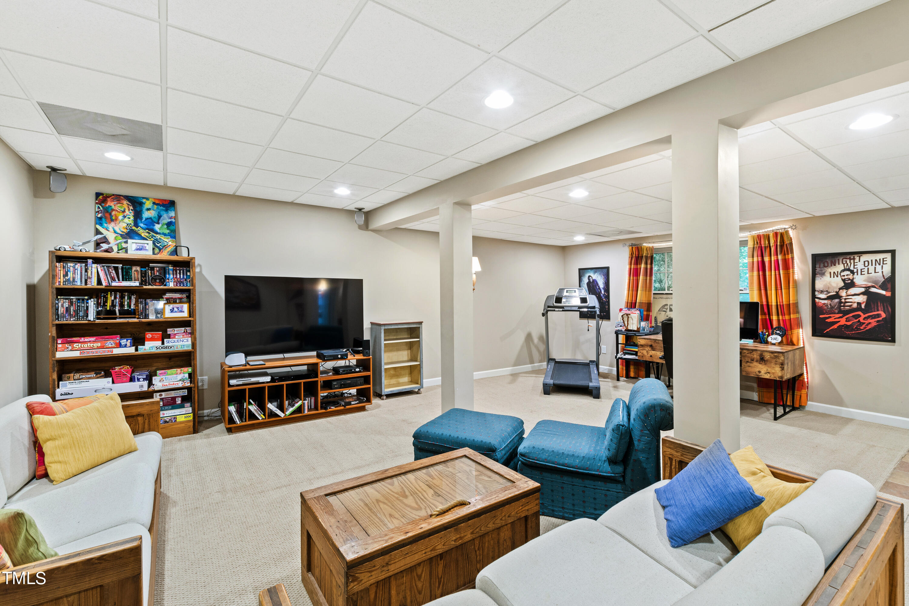 10212 Bushveld Lane Raleigh, NC 27613 - Photo 39 of 51 a living room with furniture and a flat screen tv