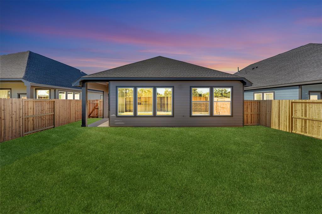 a front view of a house with a yard and garden