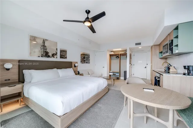 a bedroom with a bed and glass wall painting