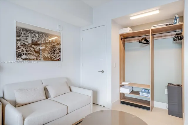 a living room with furniture and a kitchen view