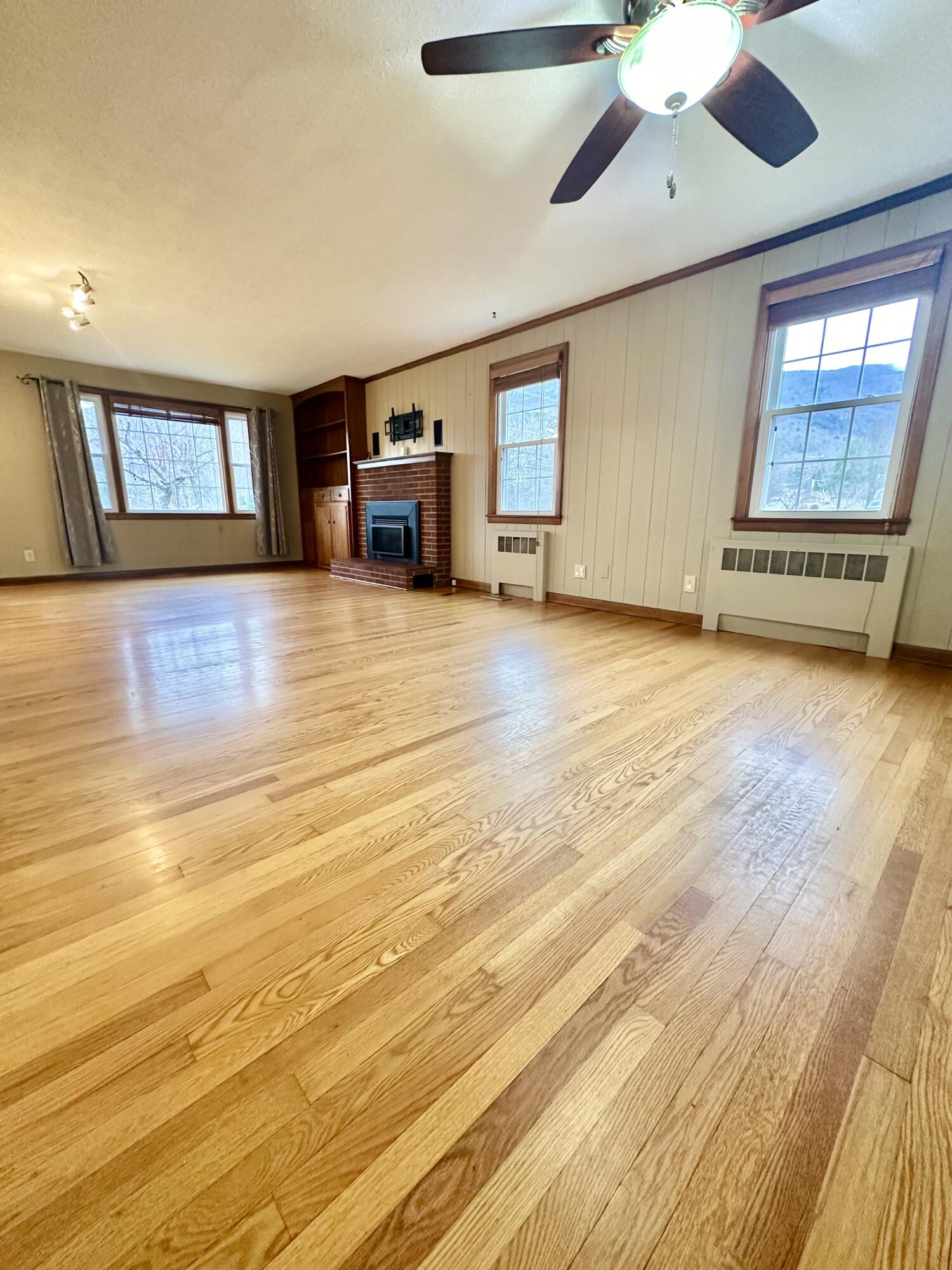 2714 Jackson River Road Covington, VA 24426 - Photo 21 of 54 a view of empty room with a fireplace and wooden floor