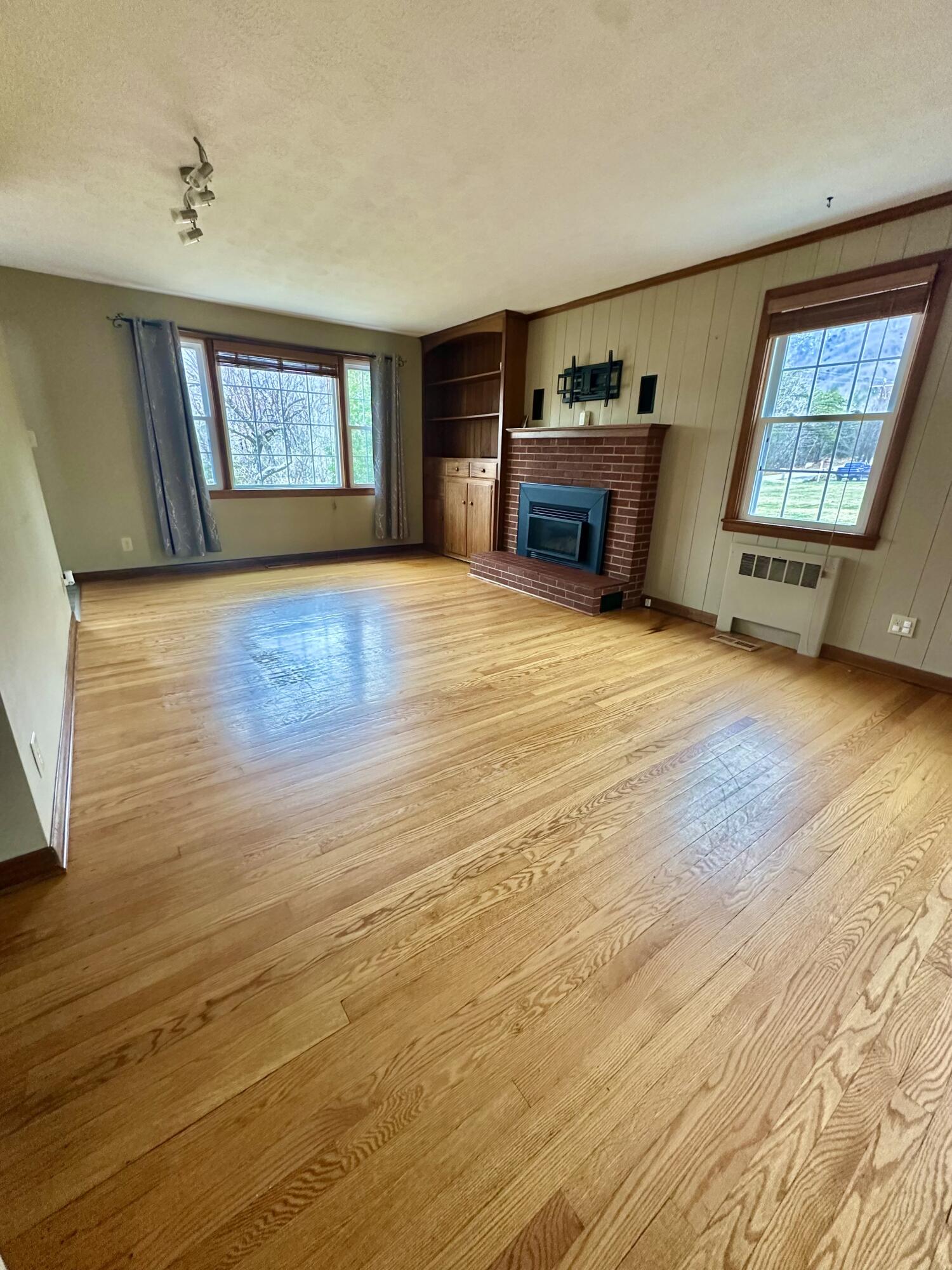 2714 Jackson River Road Covington, VA 24426 - Photo 22 of 54 a view of an empty room with a window and wooden floor