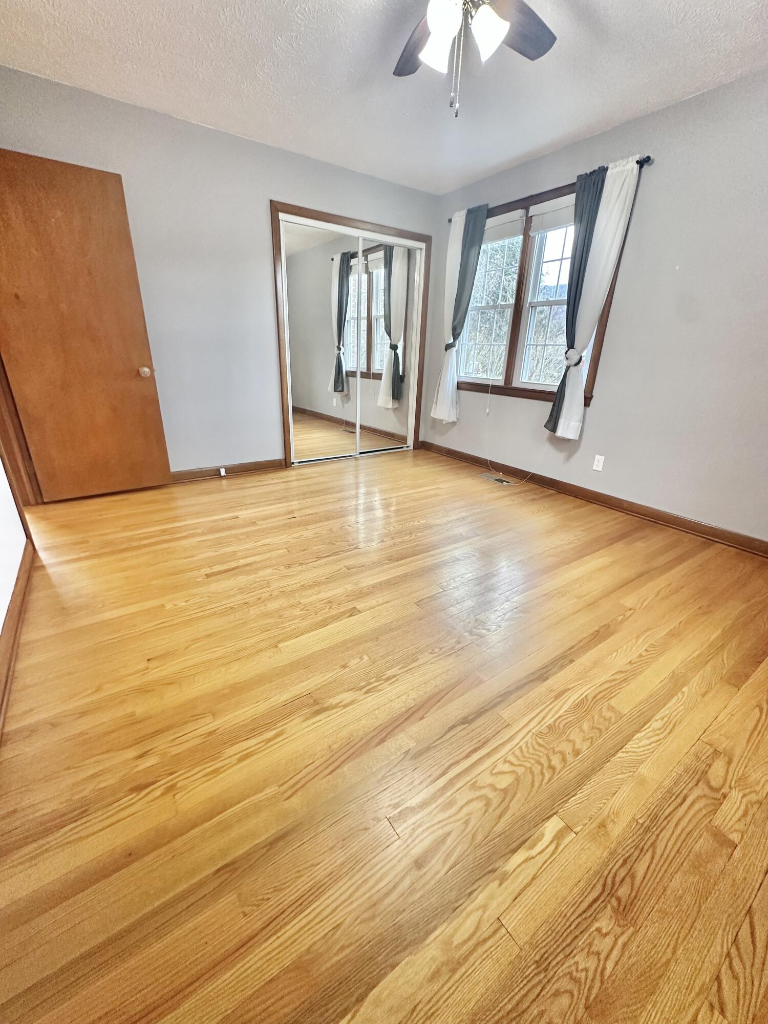2714 Jackson River Road Covington, VA 24426 - Photo 35 of 54 a view of an empty room with window and wooden floor