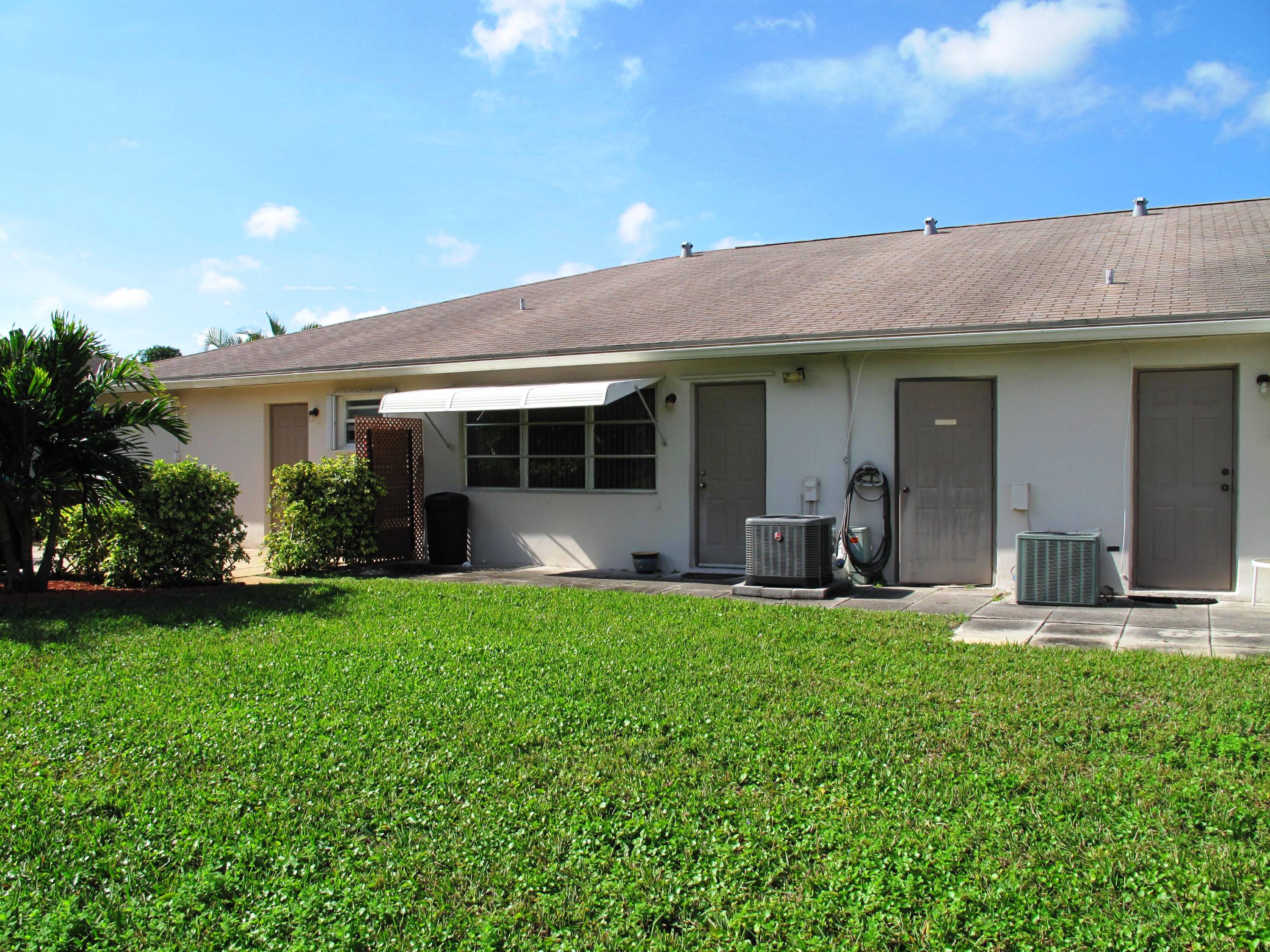 1317 High Point Way Southeast, Unit C Delray Beach, FL 33445 - Photo 28 of 40 rear exterior view of villa with plenty