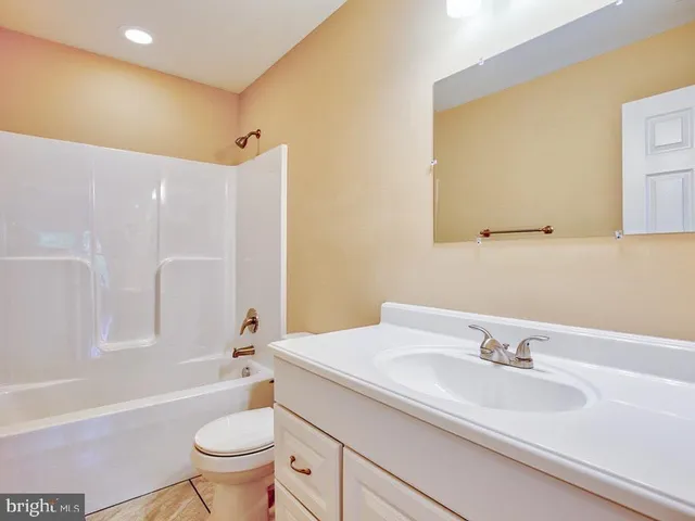 a bathroom with a sink toilet tub and shower
