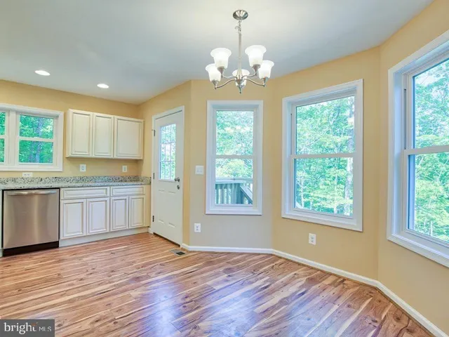 a view of a kitchen with a dishwasher cabinets and wooden floor
