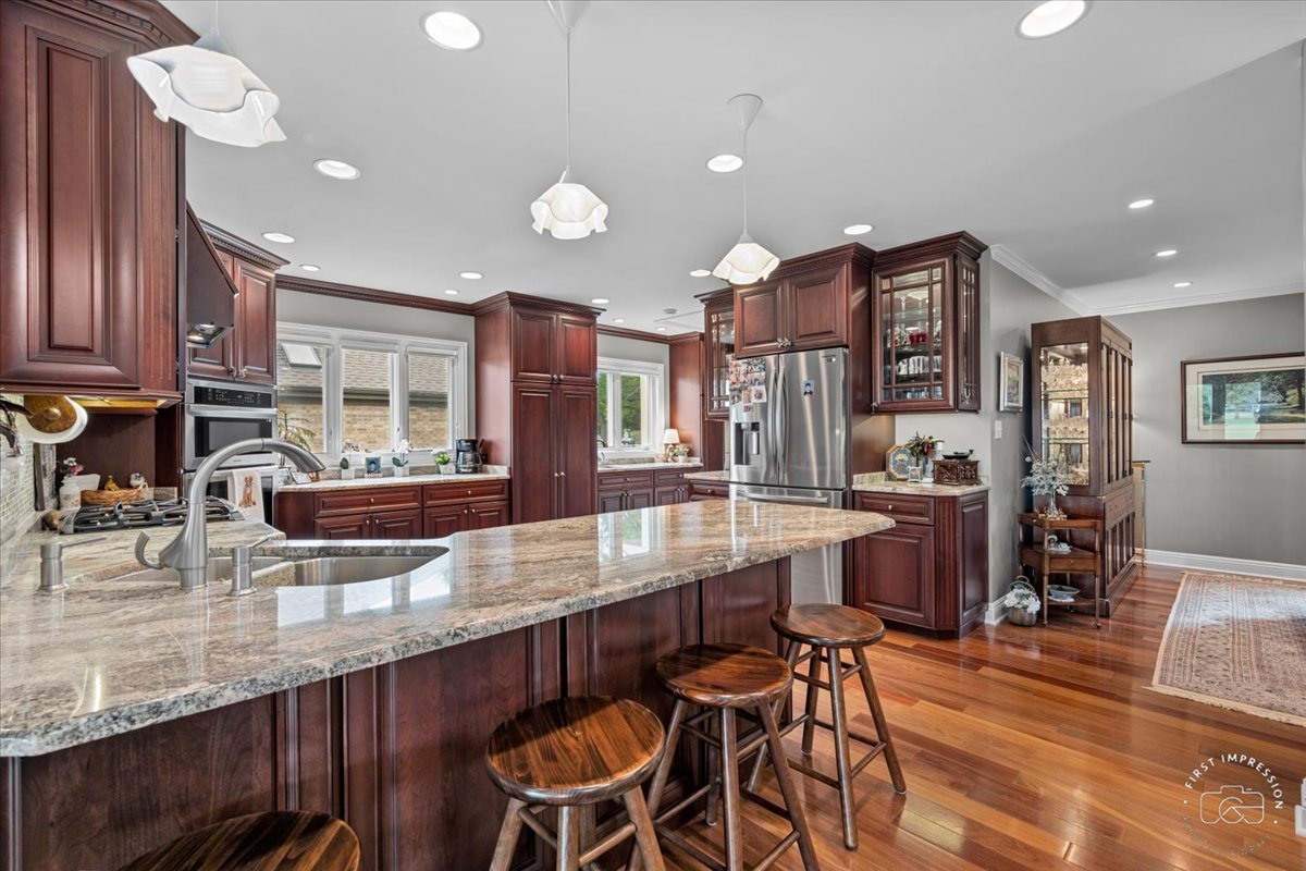 840 West Bauer Road Naperville, IL 60563 - Photo 21 of 37 a kitchen with stainless steel appliances granite countertop wooden cabinets a dining table and chairs