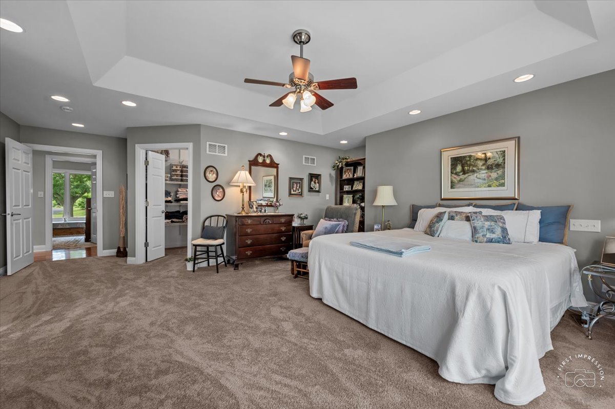 840 West Bauer Road Naperville, IL 60563 - Photo 28 of 37 a spacious bedroom with a bed a furniture and a ceiling fan