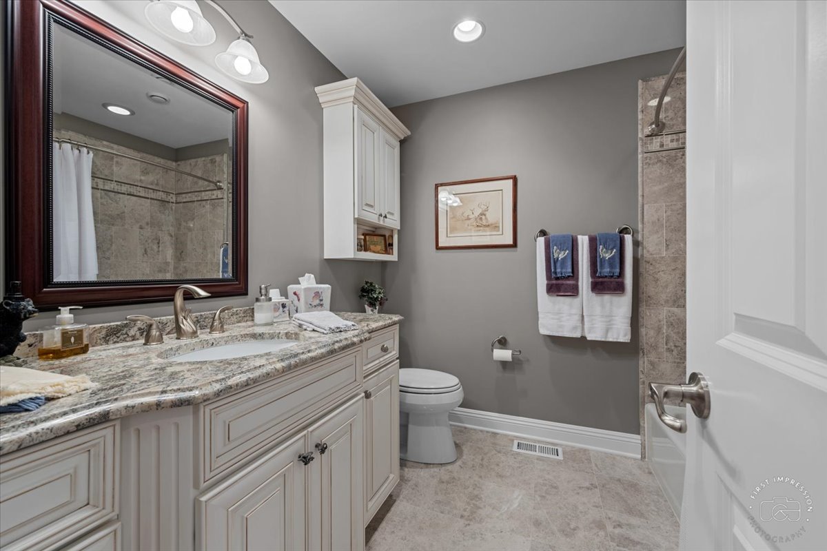 840 West Bauer Road Naperville, IL 60563 - Photo 33 of 37 a bathroom with a granite countertop sink mirror and toilet