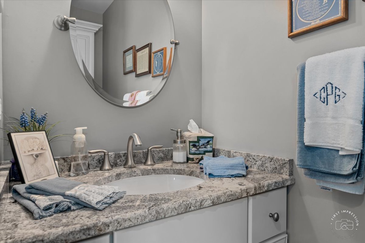 840 West Bauer Road Naperville, IL 60563 - Photo 35 of 37 a bathroom with a granite countertop sink and a mirror
