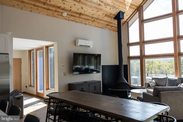 a living room with furniture and a painting on the wall