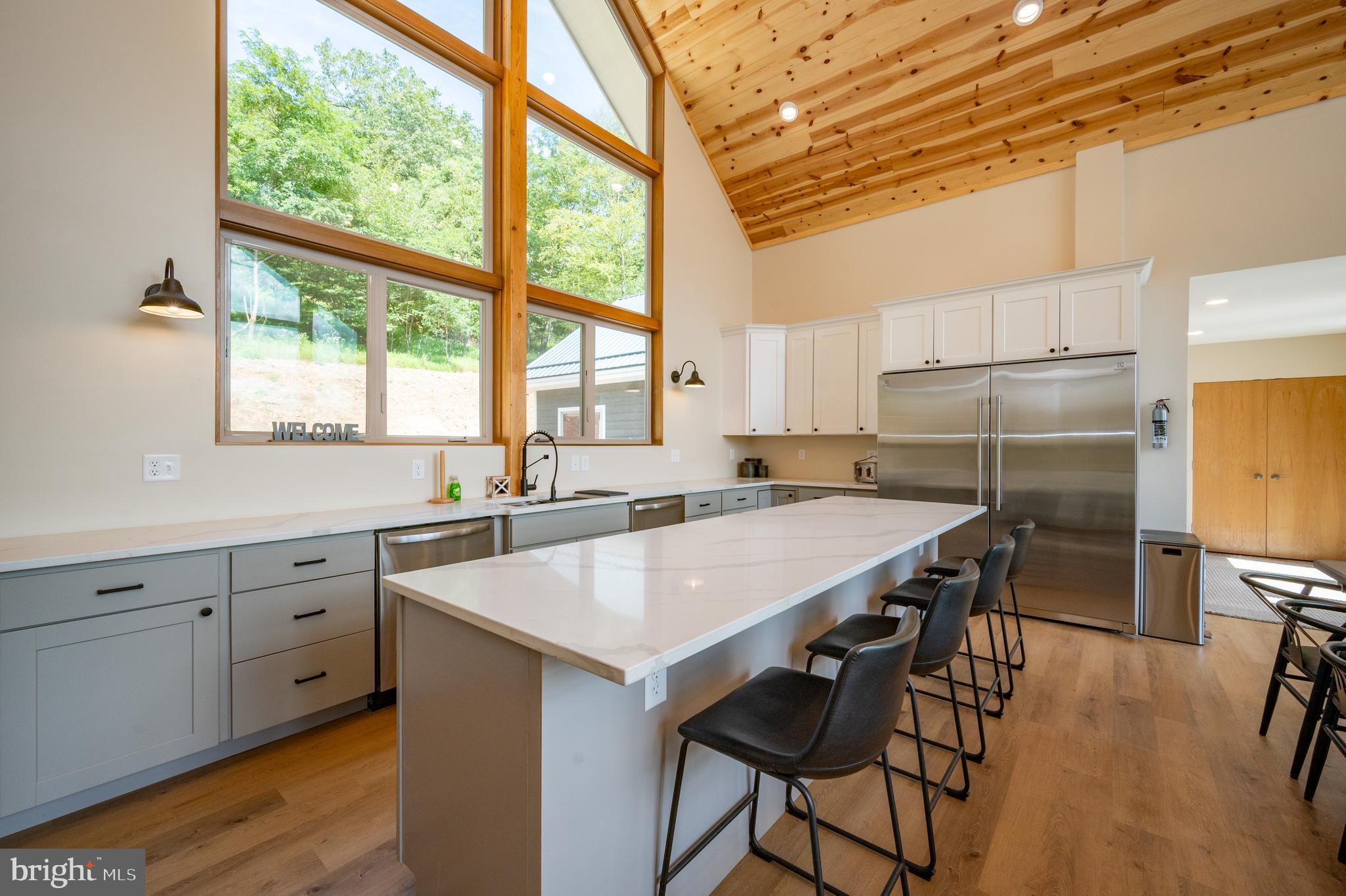 2614 Marsh Hill Road McHenry, MD 21541 - Photo 16 of 76 a kitchen with a table chairs refrigerator and cabinets