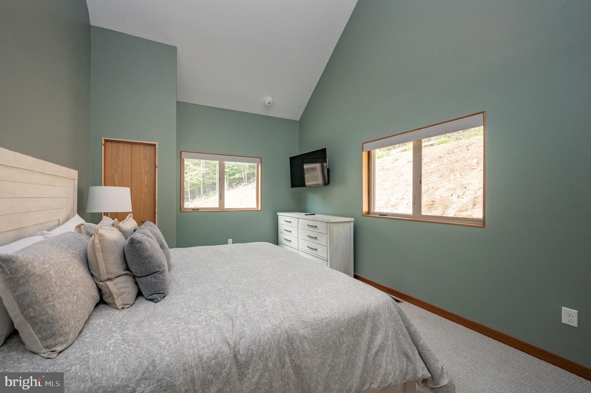 2614 Marsh Hill Road McHenry, MD 21541 - Photo 40 of 76 a bedroom with a bed and window with lamp