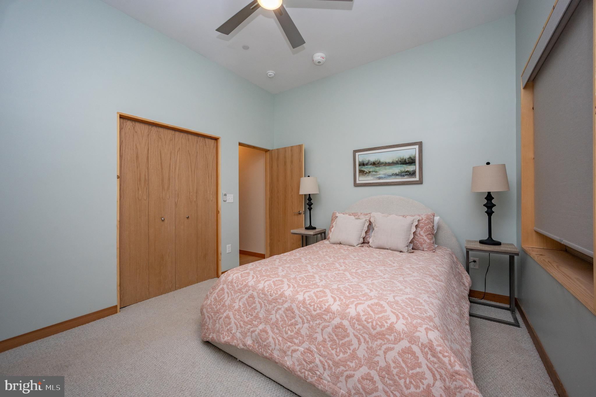 2614 Marsh Hill Road McHenry, MD 21541 - Photo 55 of 76 a bedroom with a large bed and a chandelier