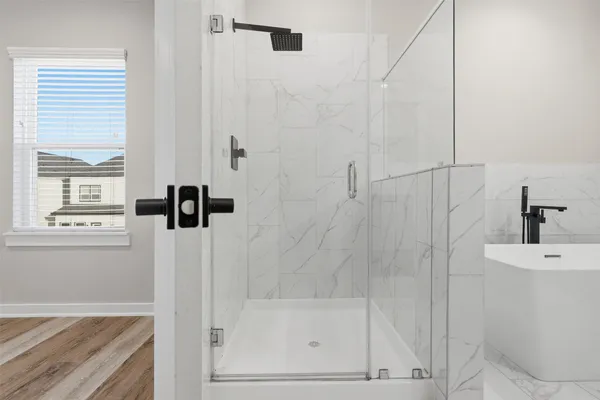 a bathroom with a double vanity sink a mirror and bathtub