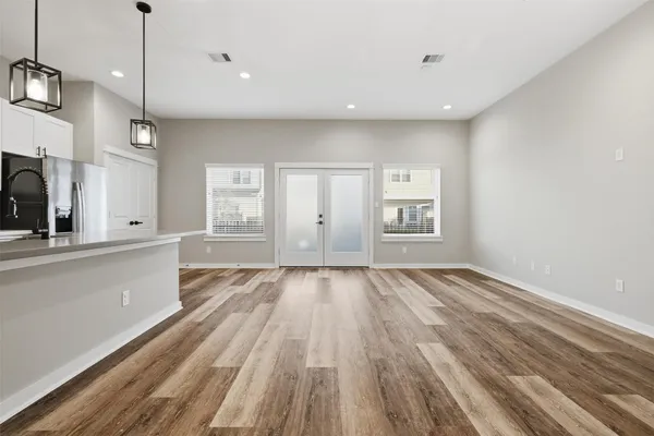 a view of kitchen with kitchen island white cabinets and stainless steel appliances