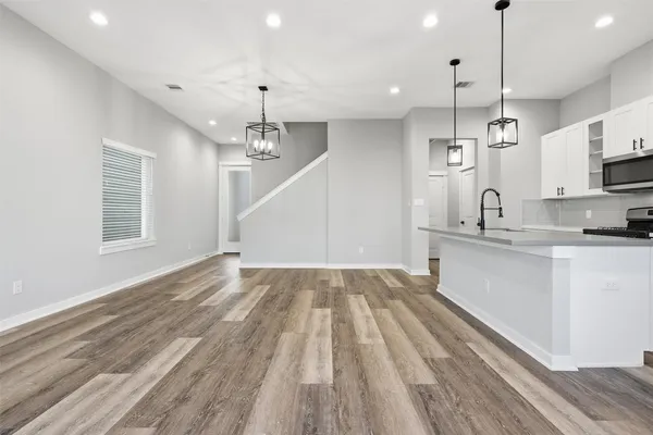 a view of a kitchen counter space a stove and a wooden floors