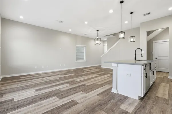 a kitchen with a sink a stove and cabinets