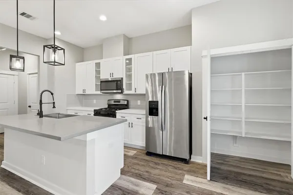 a kitchen with stainless steel appliances a refrigerator sink and microwave