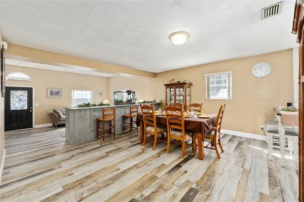 a view of a dining room with furniture and wooden floor