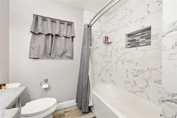 a room with furniture a flat screen tv and a window